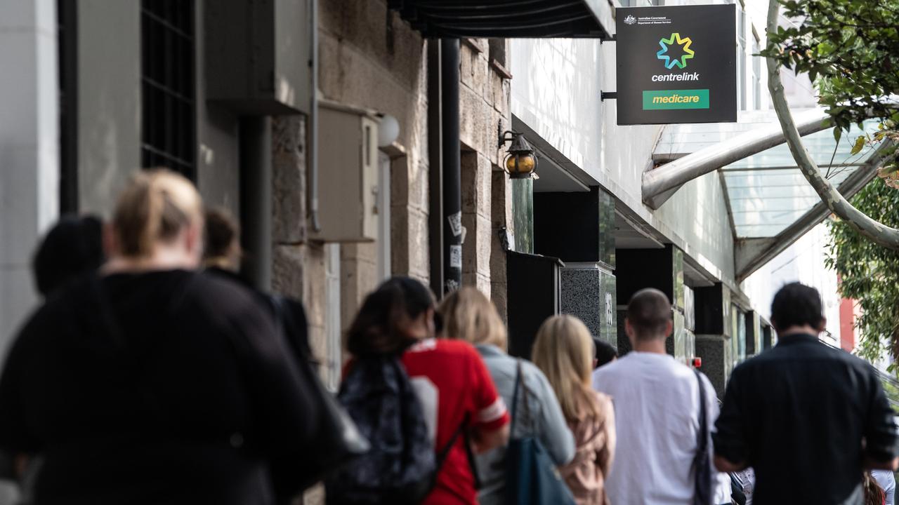 People queue for access to a Centrelink Service Centre in Sydney