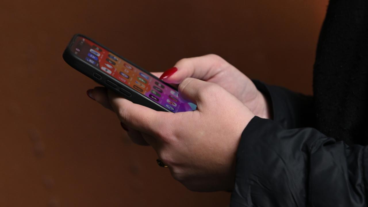 Person holding a mobile phone in Melbourne