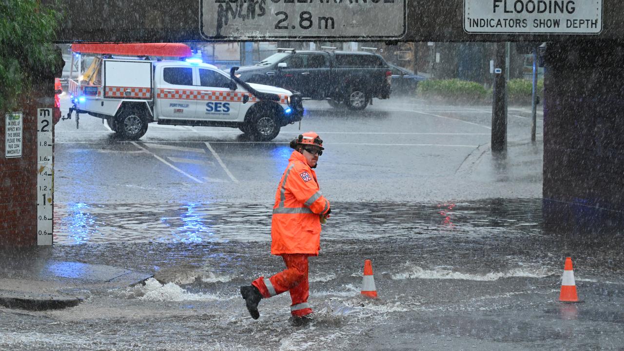 SES personnel work to block a flooded underpass in South Melbourne